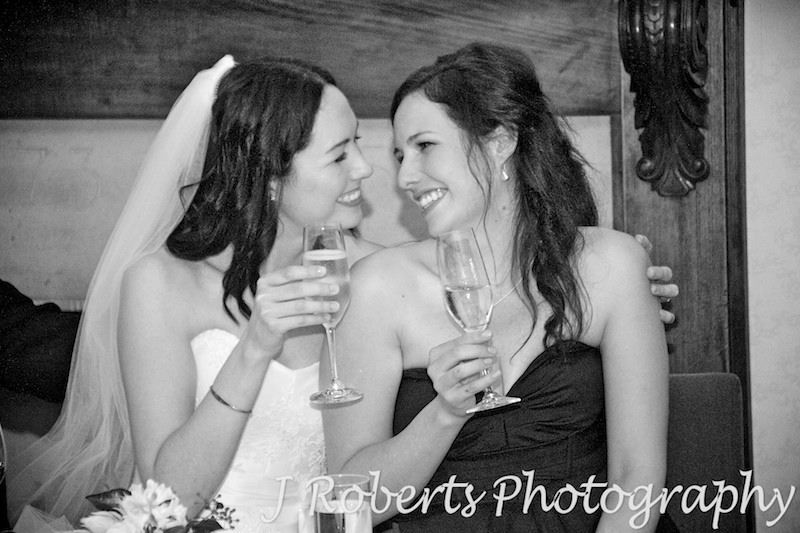 Sisters sharing a moment during wedding reception - wedding photography sydney